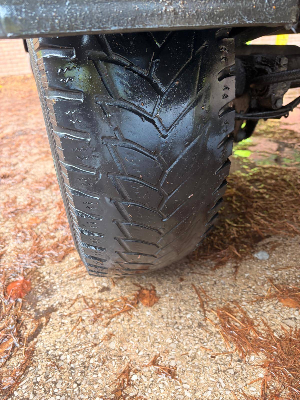 Tyre tread inspected beneath a vehicle