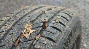 Close-up of a tyre with a nail lodged in the tread