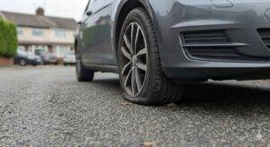 Side view of a tyre slightly squished where it meets the ground