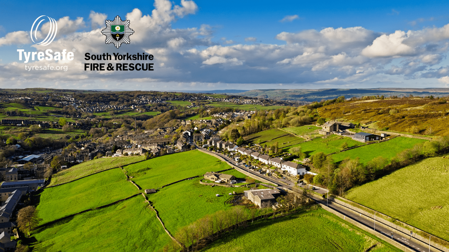 Aerial view of countryside and a village with TyreSafe and South Yorkshire Fire and Rescue logos