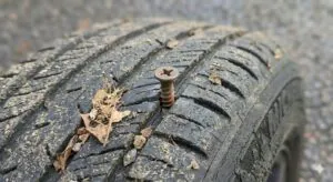 Close-up of a tyre with a nail lodged in the tread