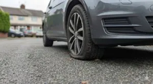 Side view of a tyre slightly squished where it meets the ground